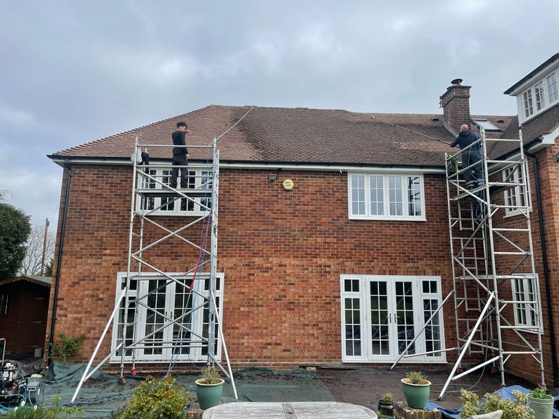 Roof cleaning carried out safely from scaffold towers by The Roof Moss Cleaners in Witney
